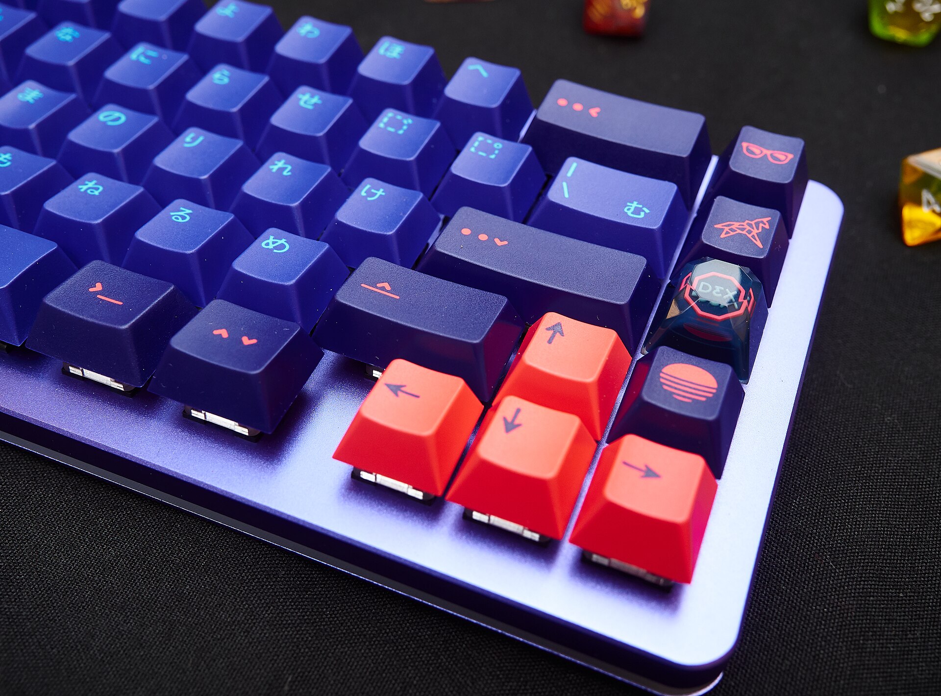Custom mechanical keyboard with coral arrow keys and dye-sublimated keycaps